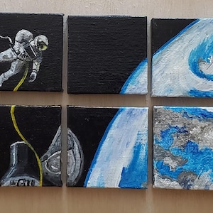 May include: Six small square paintings depicting space scenes. One shows an astronaut in a spacesuit against a black background. Other paintings show planets and space objects in shades of blue, white, and gray.