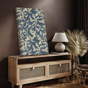May include: A blue and white canvas print with a repeating pattern of stylized birds. The print is displayed on a wooden media console with two drawers.
