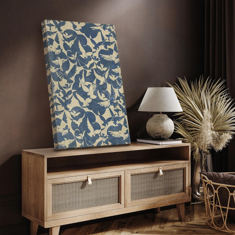 May include: A blue and white canvas print with a repeating pattern of stylized birds. The print is displayed on a wooden media console with two drawers.