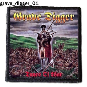 May include: A black and white embroidered patch with the text "Grave Digger" in a stylized font. The patch features a skeleton wearing a kilt and playing bagpipes in front of a battlefield scene. The text "Times Of War" is at the bottom of the patch.