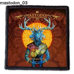 Peut inclure: Un patch noir et marron avec une image colorée d'une créature à trois têtes et des bois. La créature est entourée d'un soleil jaune et d'un motif mandala brun. Le texte "MASTODON" et "BLOOD MOUNTAIN" sont visibles sur le patch.