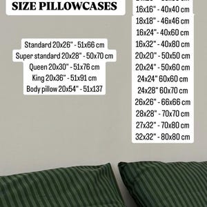May include: Image showing a list of pillowcase sizes in inches and centimeters. Sizes include standard, queen, king, and body pillow, along with other square and rectangular dimensions. Two green striped pillows are in the bottom corners.