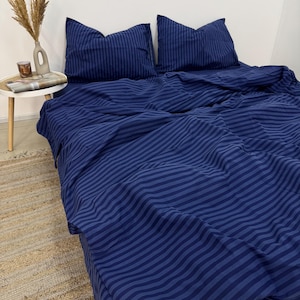 May include: A blue striped duvet cover and two matching pillowcases. The bedding is made of soft, comfortable fabric and features a classic striped pattern.