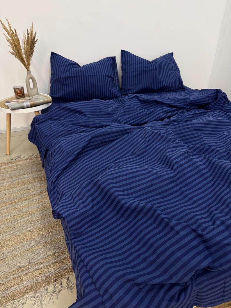 May include: A blue striped duvet cover and two matching pillowcases. The bedding is made of soft, comfortable fabric and features a classic striped pattern.