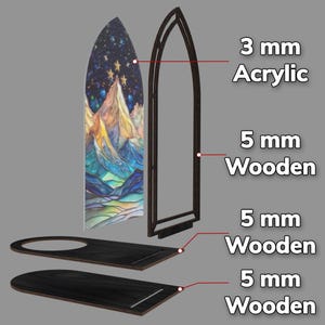 May include: An exploded view of a stained-glass-style mountain scene. The design includes a 3 mm acrylic panel with a mountain and starry night design, a 5 mm wooden frame, and two 5 mm wooden bases.
