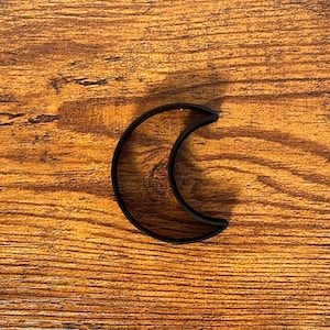 May include: Black crescent moon cookie cutter.