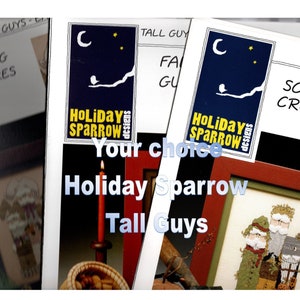 May include: A close-up of a cross-stitch pattern featuring three tall guys in red, green, and brown clothing. The pattern is titled "Tall Guys" and is from Holiday Sparrow Designs.