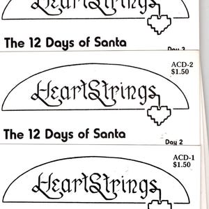 May include: Four cross-stitch patterns for the 12 Days of Santa. Each pattern features the text "HeartStrings" and a heart design. The patterns are numbered 1 through 5. The fifth pattern shows a cross-stitch design of Santa Claus.