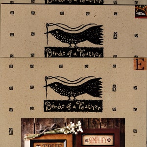 May include: Three framed cross-stitch patterns with a rustic wood background. The patterns are "Birds of a Feather", "Simplify", and "True".