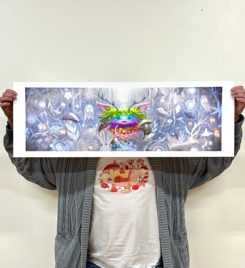 May include: A colorful, whimsical creature with antlers and a rainbow-colored body stands in a snowy forest. The creature is surrounded by white trees and a light blue sky. The image is a digital illustration.