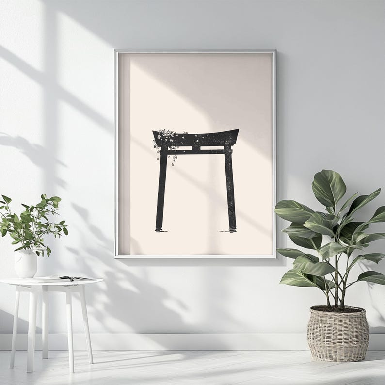 May include: A black and white minimalist print of a traditional Japanese torii gate with a floral design. The gate is set against a light beige background.
