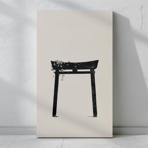 May include: A black silhouette of a traditional Japanese torii gate with white flowers hanging from the top. The gate is set against a light beige background.