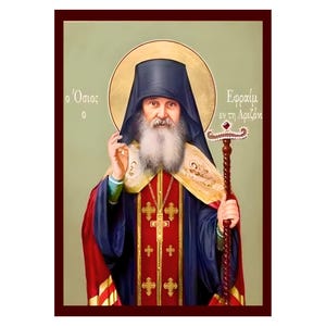Peut inclure: Icône d'une figure religieuse à barbe blanche, portant un chapeau noir et des robes rouges, bleues et dorées. La figure tient une crosse et se détache sur un halo doré et un fond vert clair. Du texte grec est visible.