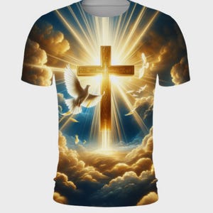 May include: A white t-shirt with a graphic print of a golden cross surrounded by white doves and clouds. The cross is shining brightly with a golden glow.