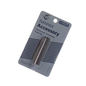 May include: A Naniwa Accessory kitchen knife sharpening guide clip. The clip is silver and packaged on a gray and white card. The card has the Naniwa logo and text that reads "Accessory Kitchen Knife Sharpening Guide Clip".