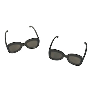 May include: Two pairs of black plastic sunglasses with oval lenses.