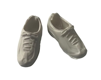 May include: A pair of white trainers with laces. The trainers have a simple design and are made of a smooth material.