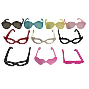 May include: A collection of colorful sunglasses in various styles and hues. The assortment includes shades of black, blue, yellow, pink, and red. Some frames are classic, while others feature heart-shaped or unique designs.
