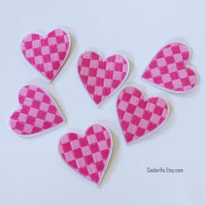 May include: Six heart-shaped patches with a pink and white chequered pattern. Each patch has a white border. The patches are arranged on a white surface. The text "Coolarific.Etsy.com" is visible in the bottom right corner.