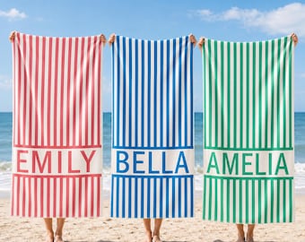 May include: Three rectangular beach towels featuring vertical stripes in red, blue, and green. Each towel has a solid white horizontal band across the lower section with the names EMILY, BELLA, and AMELIA printed in bold, uppercase capital letters.