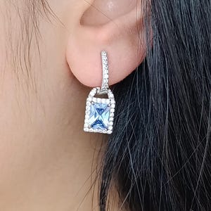 Rhodium Sterling Silver Tanzanite Dangle Earrings: Zircon Accents
