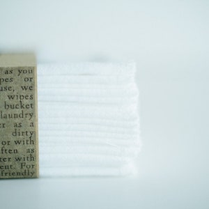 May include: A stack of white cloth wipes with a brown label that reads "cloth wipes as you regular wipes or Der. After use, we nd that the wipes in either a bucket bag with laundry and water as a Launder dirty themselves or with apers as often as sing hot water with prite detergent. For lutely eco-friendly"