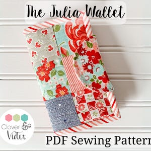 May include: A patchwork fabric wallet with red, white, and blue floral patterns. The wallet is called "The Julia Wallet" and is a PDF sewing pattern.