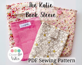 May include: A PDF sewing pattern for a book sleeve, featuring a floral fabric with a pink button. The pattern is called "The Katie Book Sleeve" and is by Clover & Vitex.