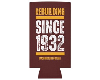 May include: A maroon can cooler with the text "REBUILDING SINCE 1932 WASHINGTON FOOTBALL" in white and yellow.