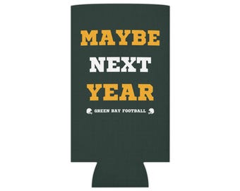 May include: Green and black can cooler with the text "MAYBE NEXT YEAR" in yellow and white. The text "GREEN BAY FOOTBALL" is in white with a football helmet icon on either side.