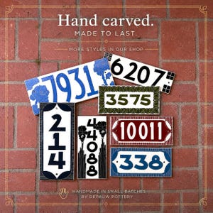 May include: A collection of rectangular ceramic house number plaques featuring various designs, including blue floral patterns, black numbers on white, green borders, and red or blue frames, with text reading Hand carved. MADE TO LAST.