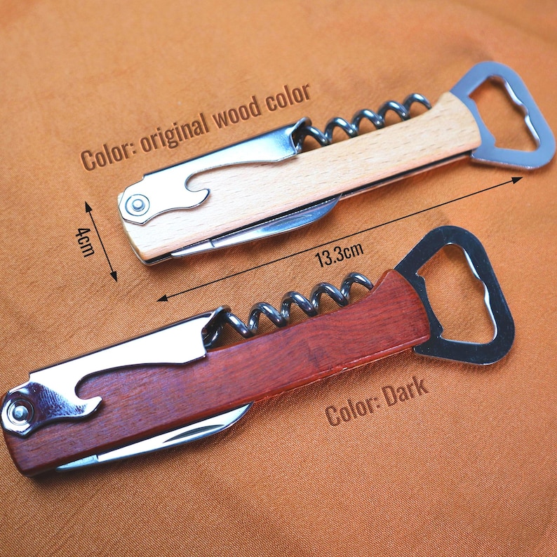 May include: Two wooden wine bottle openers with stainless steel components. One is light wood, the other is dark wood. Each opener has a corkscrew, bottle opener, and small knife. The openers are 13.3 cm (5.2 inches) long and 4 cm (1.6 inches) wide.