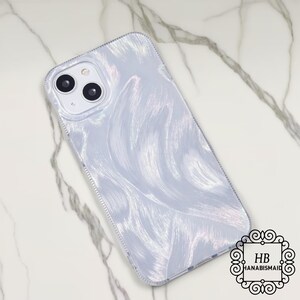 May include: A pearlescent phone case with a swirling, brushstroke design in shades of white and silver. The case has a clear border and a camera cutout. The logo "HB HANABISMAID" is in the bottom right corner.