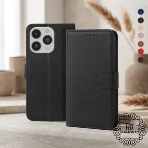 May include: Black leather phone case with a wallet design. The case has a magnetic closure and a textured surface. The phone case is shown open and closed. The image also shows a color palette of available colors.