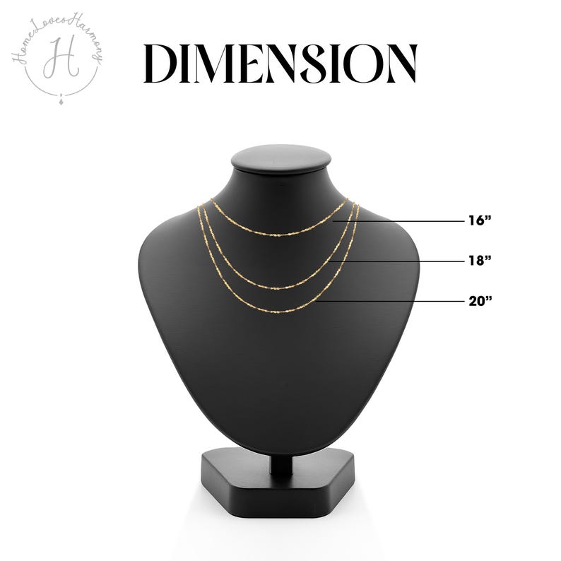 May include: A black necklace display featuring three gold necklaces, measuring 40.6, 45.7, and 50.8 cm in length. The word "DIMENSION" is printed in bold black letters above the display. The necklaces are delicate and elegant.