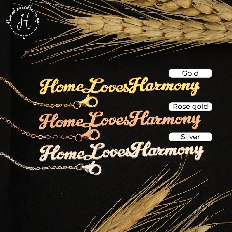 May include: Three nameplate necklaces in gold, rose gold, and silver, each featuring the script text HomeLovesHarmony. Each necklace includes a delicate chain with a lobster claw clasp. The labels Gold, Rose gold, and Silver are visible.