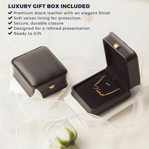 May include: Two black rectangular jewelry boxes with gold-tone latches. One box is closed, and the other is open, revealing a gold-tone name necklace resting on a black velvet interior. Text reads: LUXURY GIFT BOX INCLUDED, Premium black leather with an elegant finish, Soft velvet lining for protection, Secure, durable closure, Designed for a refined presentation, Ready to Gift.