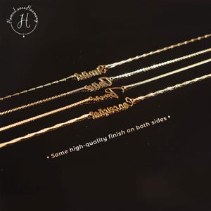 May include: Four gold-toned necklaces with cursive name pendants arranged diagonally. Each necklace features a distinct chain style. The text "HomeLovesHarmony" with an H logo is in the top left, and "Same high-quality finish on both sides" is at the bottom.
