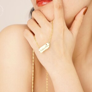 May include: A gold-toned necklace featuring a pendant shaped like the island of Puerto Rico. The pendant is engraved with the cursive text 'Custom Name' and includes a small heart symbol. The necklace has a twisted rope chain design.
