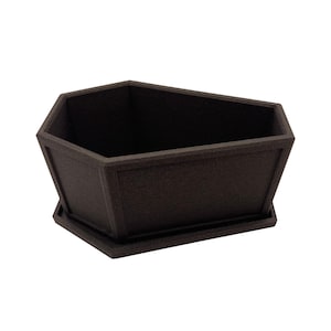 May include: A dark brown, geometric planter box with a textured surface. The planter has a rectangular shape with angled sides and a matching base. The open top allows for planting flowers or other greenery. The planter is designed for indoor or outdoor use.