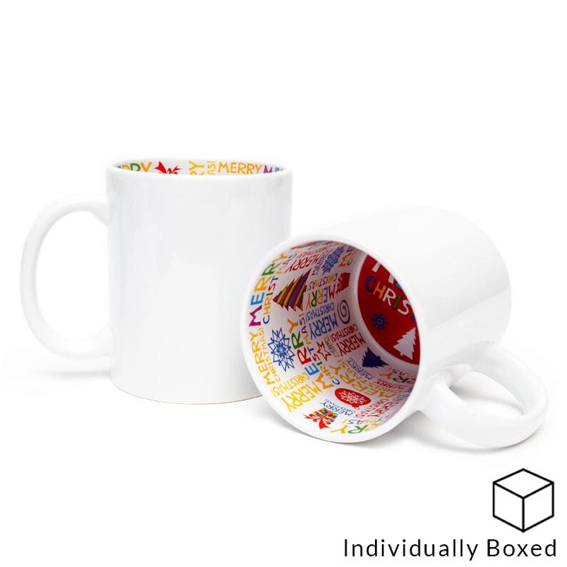 May include: Two white ceramic mugs with a colorful Christmas design printed on the inside of the mugs. The mugs are individually boxed.