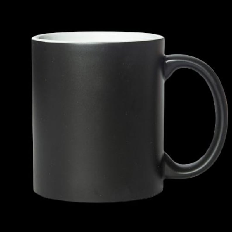 May include: A black ceramic coffee mug with a white interior. The mug has a rounded handle.