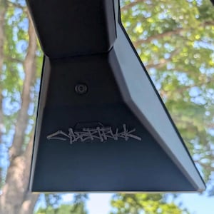 May include: Black triangular rearview mirror with a small camera lens and the word "CHERRY" written in a stylized font.