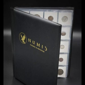 May include: Black coin album with the gold text "NUMIS Elegance in Protection" and a gold eagle logo. The album is open, revealing several coin holders with various coins inside. The background is black.