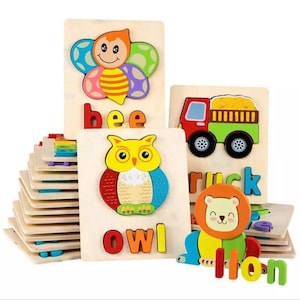 May include: A set of wooden puzzle pieces featuring colorful animal illustrations and the corresponding letter spelling out the animal's name. The set includes a bee, owl, truck, and lion.