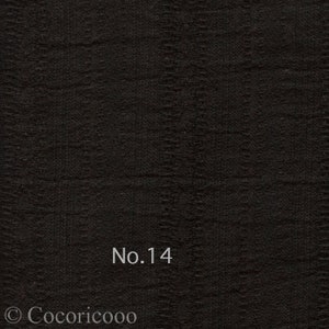 May include: Black fabric with a textured woven pattern. The fabric has a subtle sheen and is labeled "No. 14".