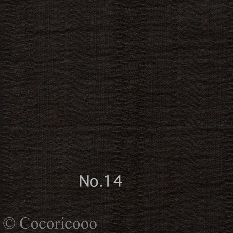 May include: Black fabric with a textured woven pattern. The fabric has a subtle sheen and is labeled "No. 14".