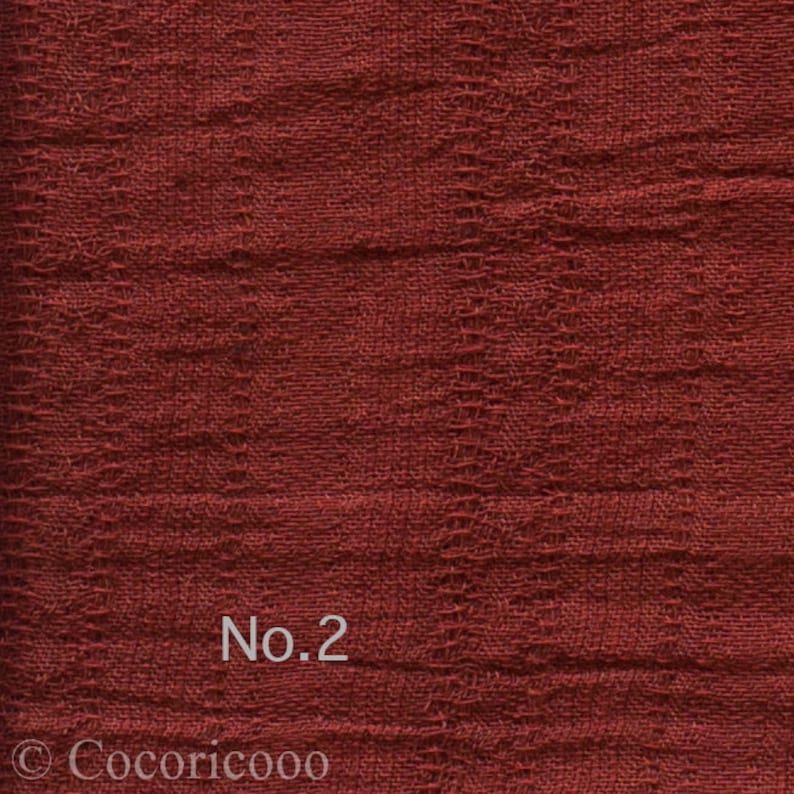 May include: Close-up of a textured, reddish-brown fabric with the text "No.2" printed on it.