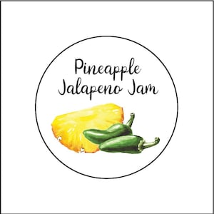 May include: A round label with the text "Pineapple Jalapeno Jam" in black cursive font. A slice of pineapple and two green jalapeno peppers are illustrated on the label.