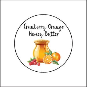 May include: A round label with black text that reads "Cranberry Orange Honey Butter". The label features a jar of honey, a whole orange, a slice of orange, and cranberries.